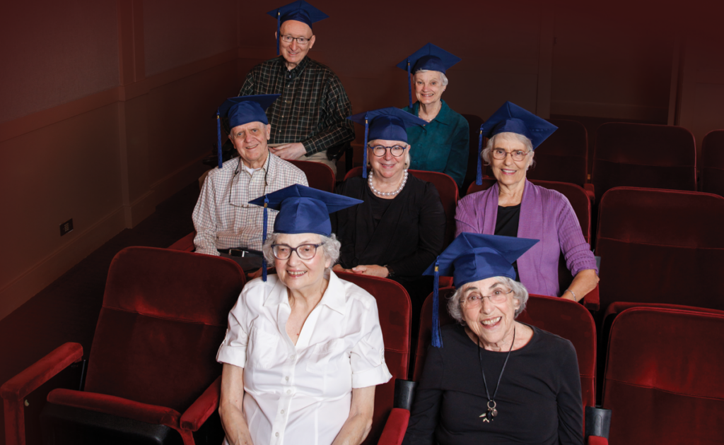 Seniors wearing graduation caps in the theater at The Garlands