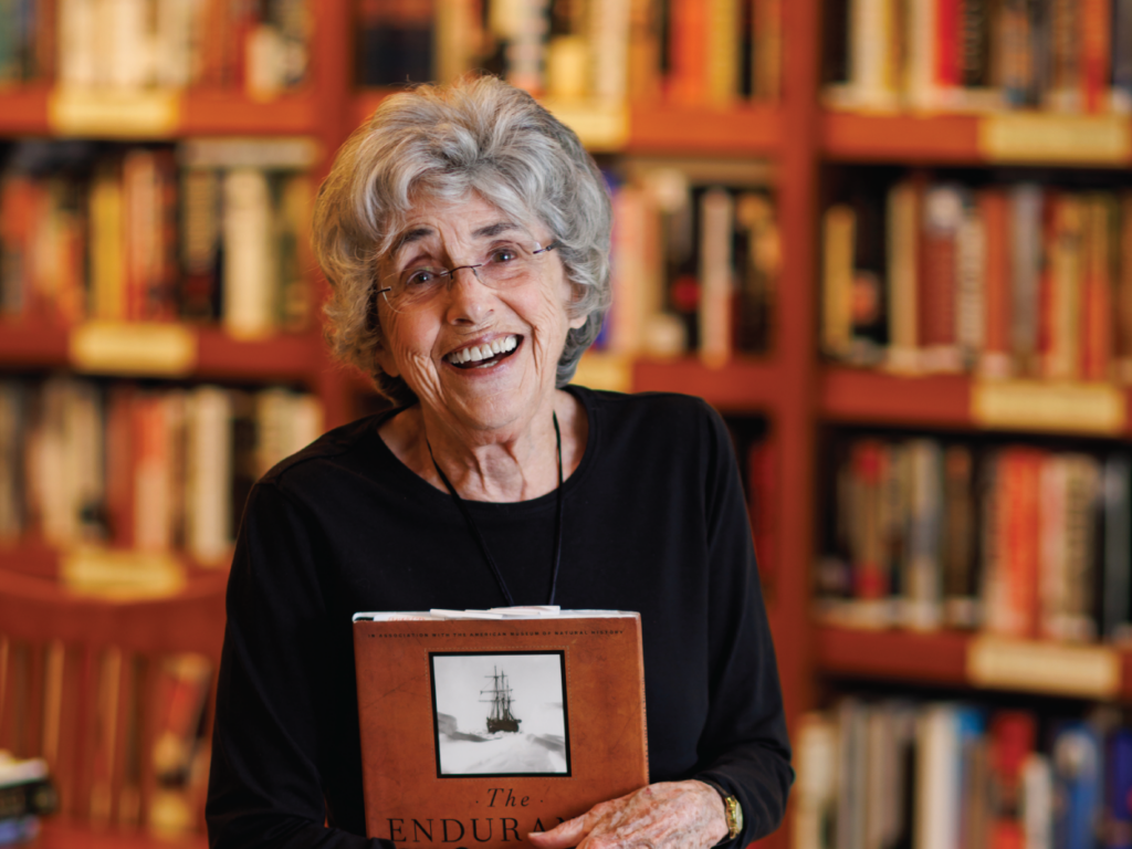 Lanny Ori in the library holding a book