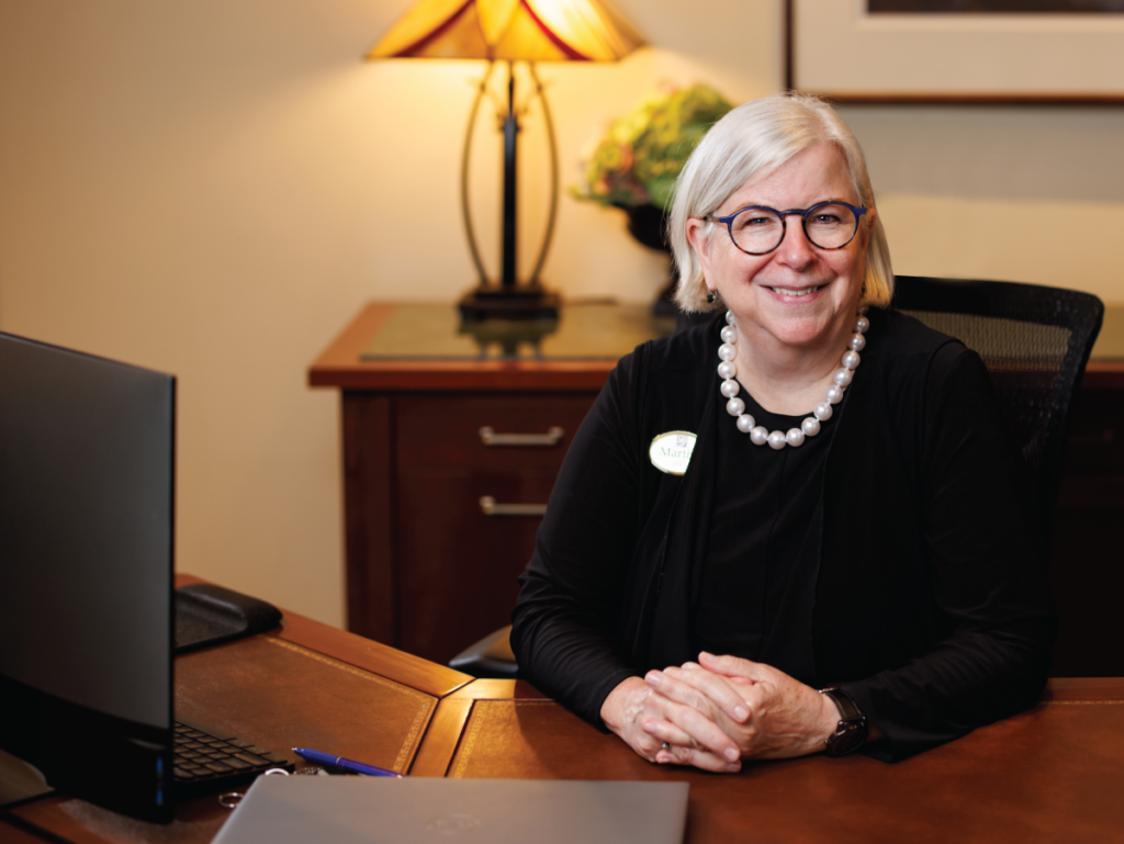 Martha sitting at her concierge desk