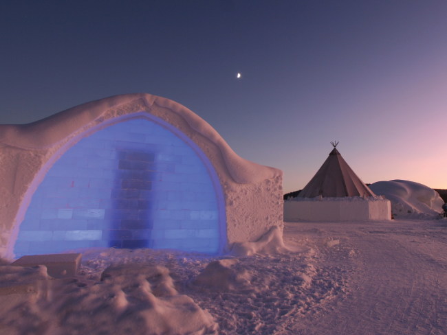 blue ice hotel with dusk sky in Norway